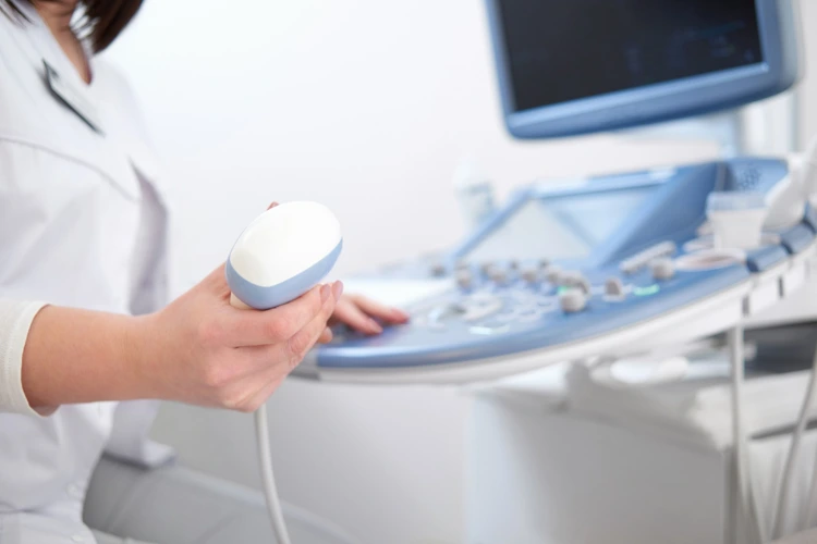 Doctor operating an ultrasound machine.